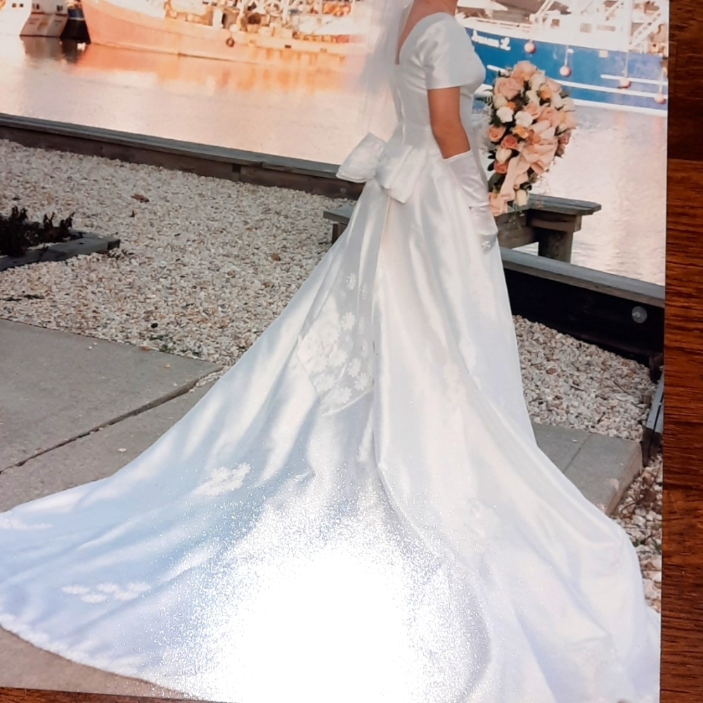Wedding dress with trane.  Flower detail on bottom of dress. Size 5